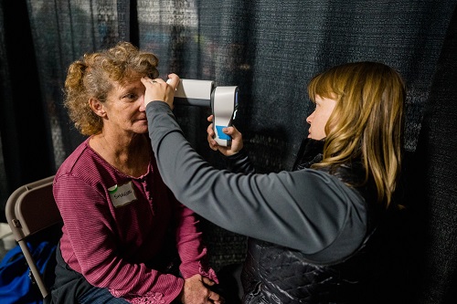 Rebekah Gensure, MD, PhD, examines a patient at the 2019 annual Project Homeless Connect event in Salt Lake City.