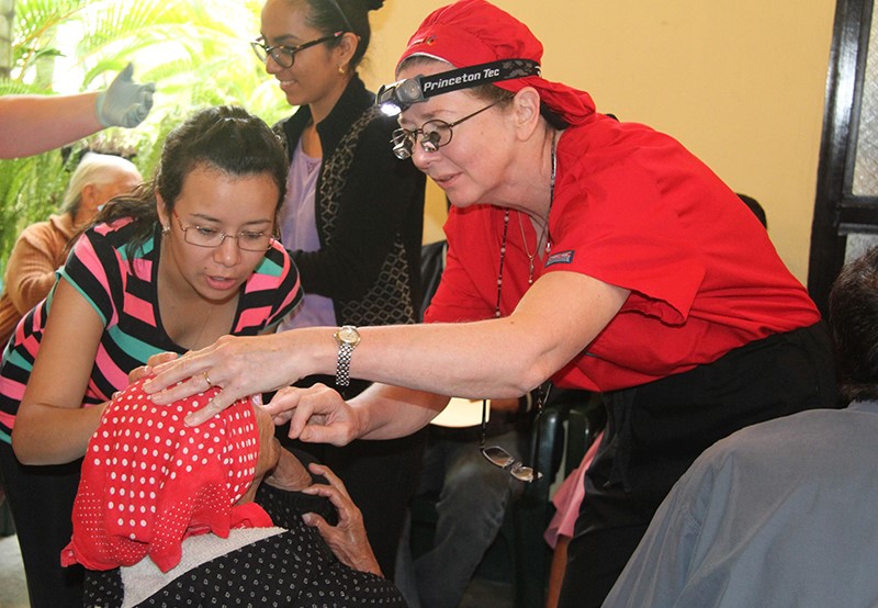 Jane Durcan, MD, right, examines a patient during a 2014 outreach trip in Guatemala.