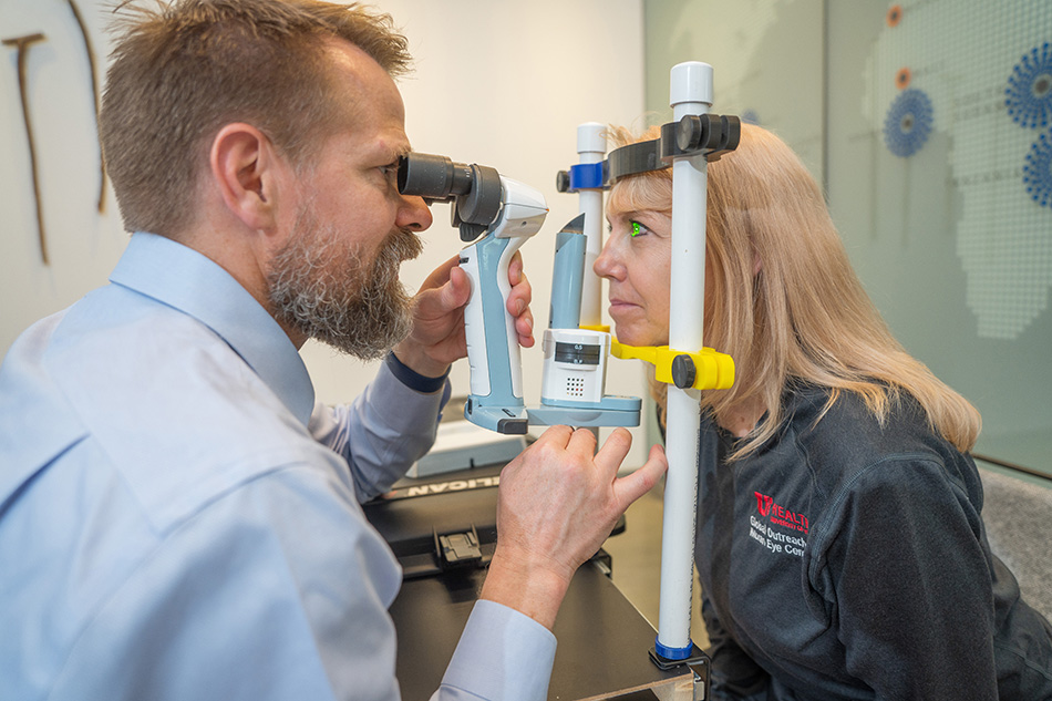 Global Outreach Division Co-Medical Director Jeff Pettey, MD, MBA, and Lori McCoy, outreach program manager, test the portable eye exam kit developed by a group of University of Utah mechanical engineering students.