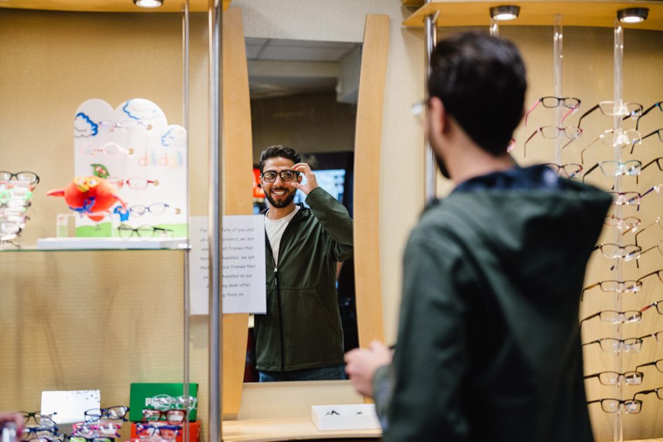 Luay, a former Syrian refugee, tries on new eyeglasses during Moran’s Hope in Sight Redwood Outreach Clinic on Saturday, Aug. 21, 2021.