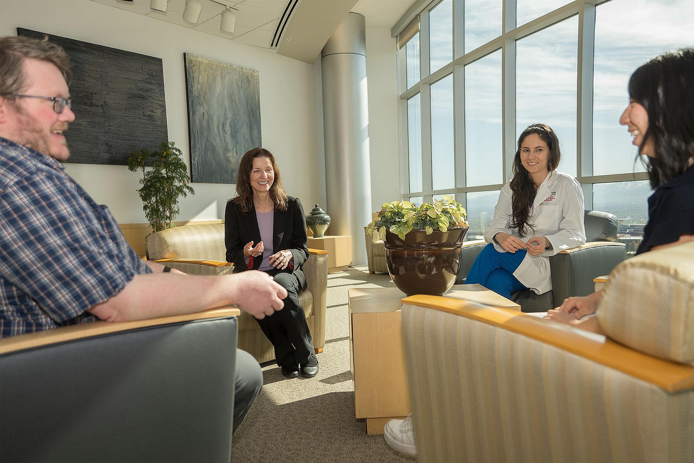 Mary Elizabeth Hartnett, MD, center, meets with a group associated with her lab, from left, Eric Kunz, Maria Margarita Parra, and Sarah Lee.