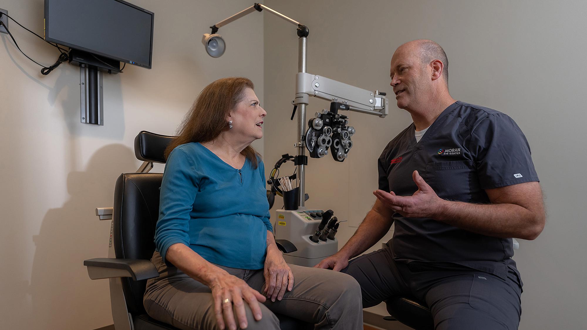 Mark Mifflin, MD, right, and patient Janice Evans, at the Midvalley Moran Eye Center.
