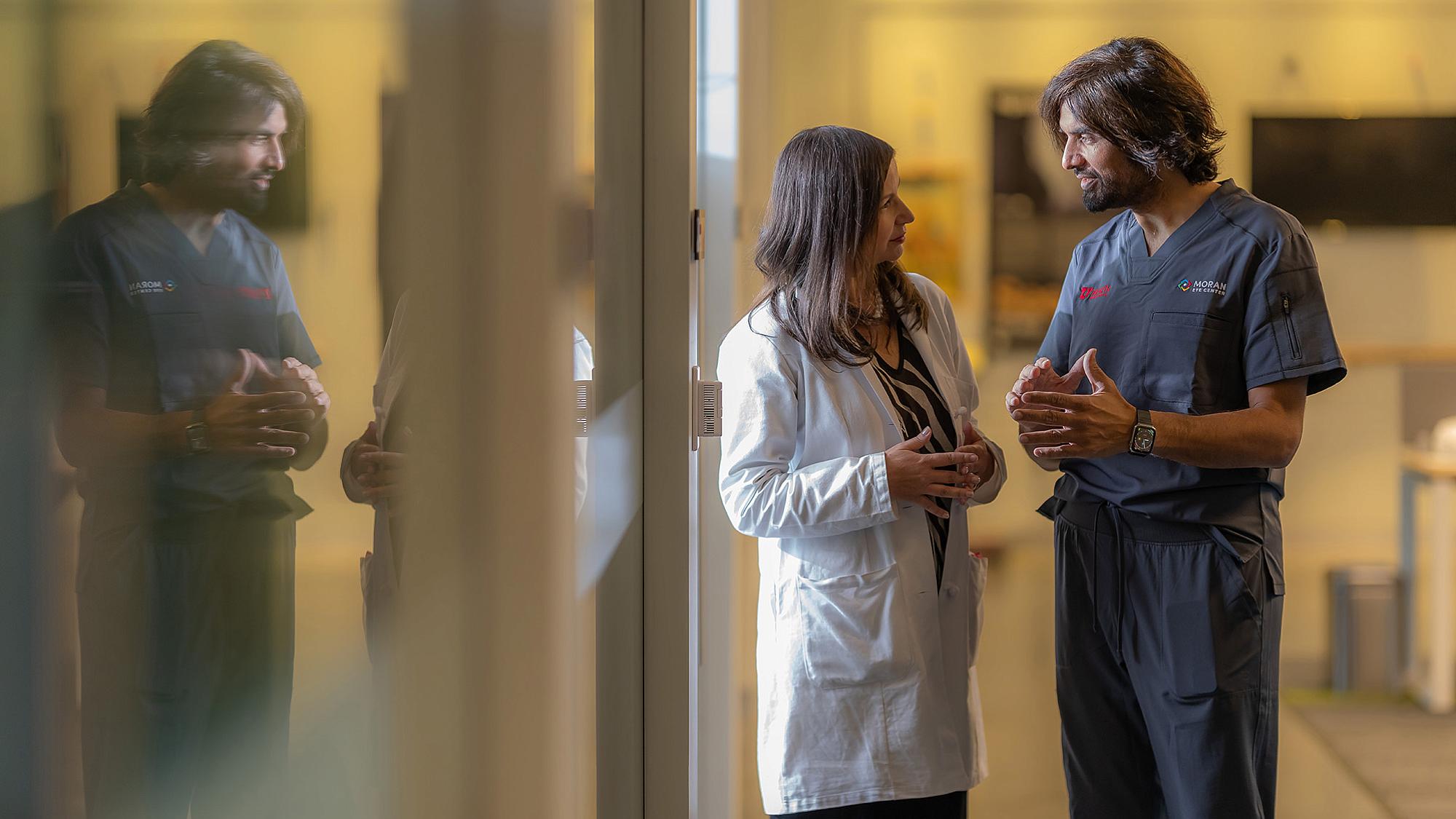 Crandall Center Director Ike Ahmed, MD, speaks with Moran colleague Liliana Werner, MD, PhD, co-director of the Intermountain Ocular Research Center.