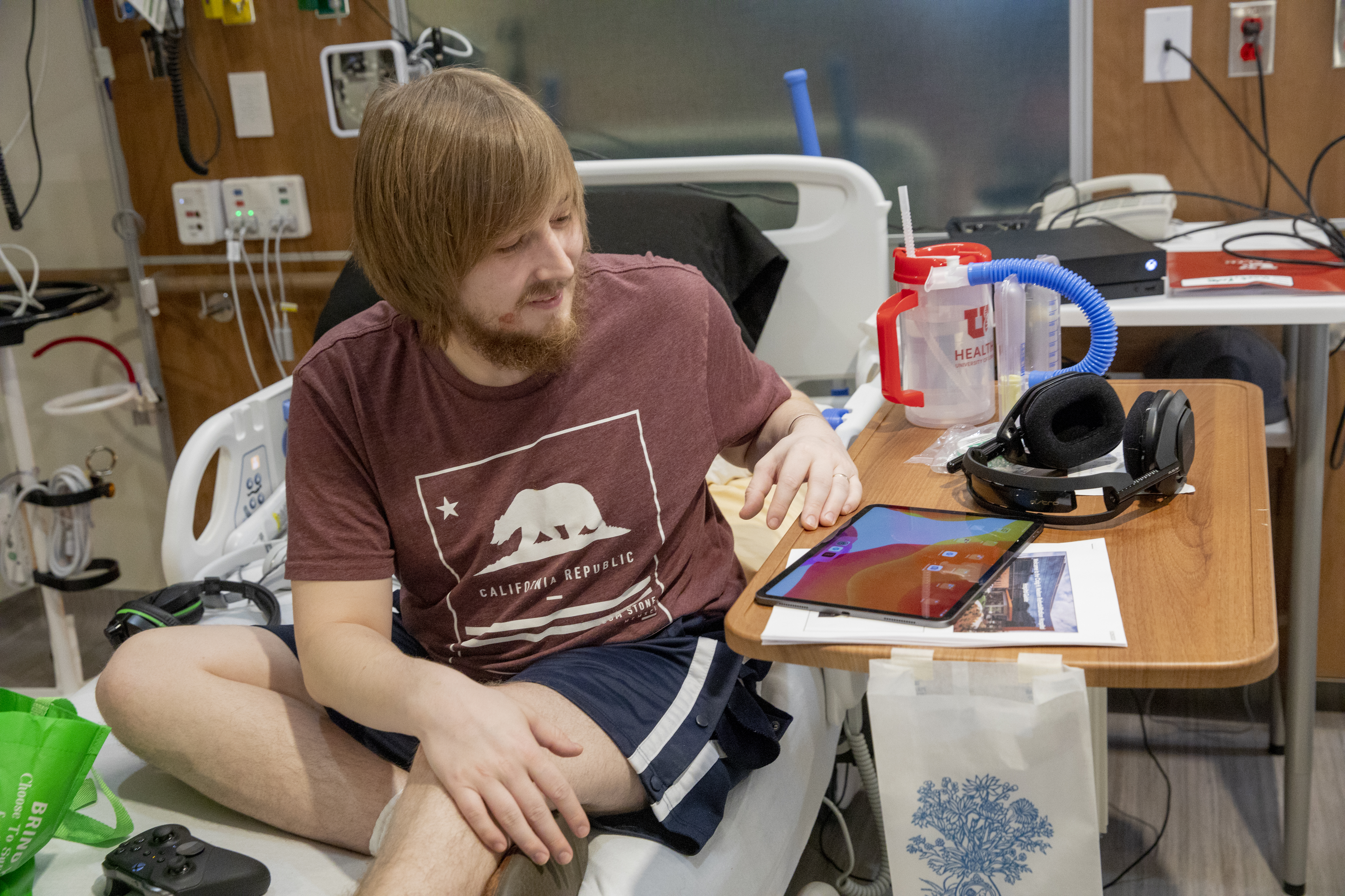 Picture of patient using an iPad in Neilsen Rehab hospital room