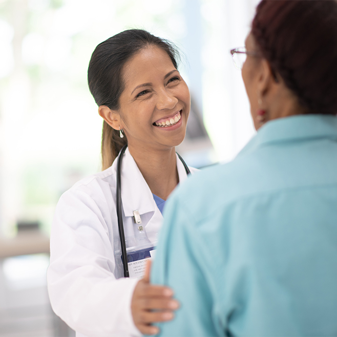 Picture of BIPOC female doctor smiling at Black female patient