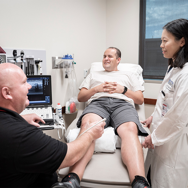 Picture of patient with Dr. Lim during an exam. 