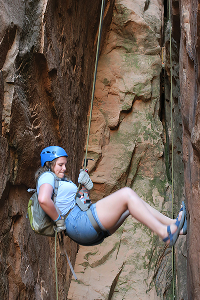 a woman rappelling