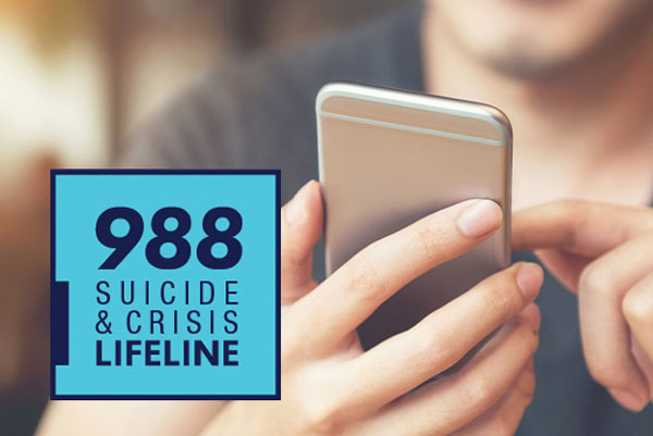 Picture of hand texting on phone with the 988 Suicide & Crisis Lifeline logo in light blue in the bottom left hand corner