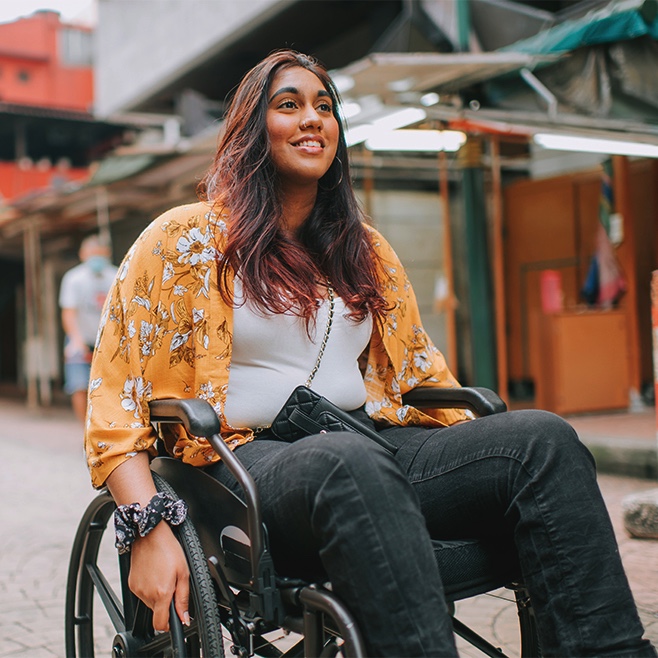 girl in a wheelchair smiling