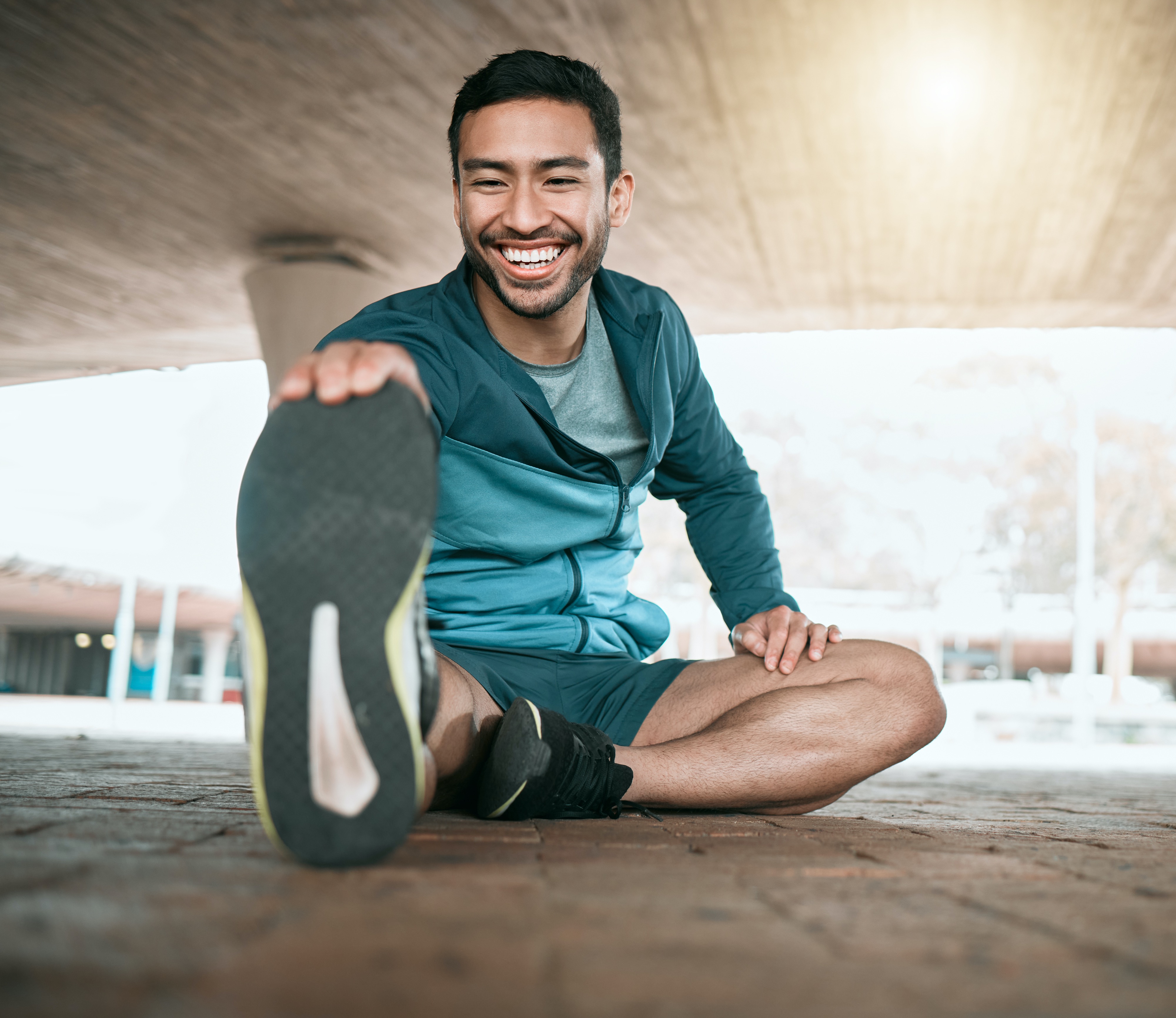 man stretching his knee before a jog