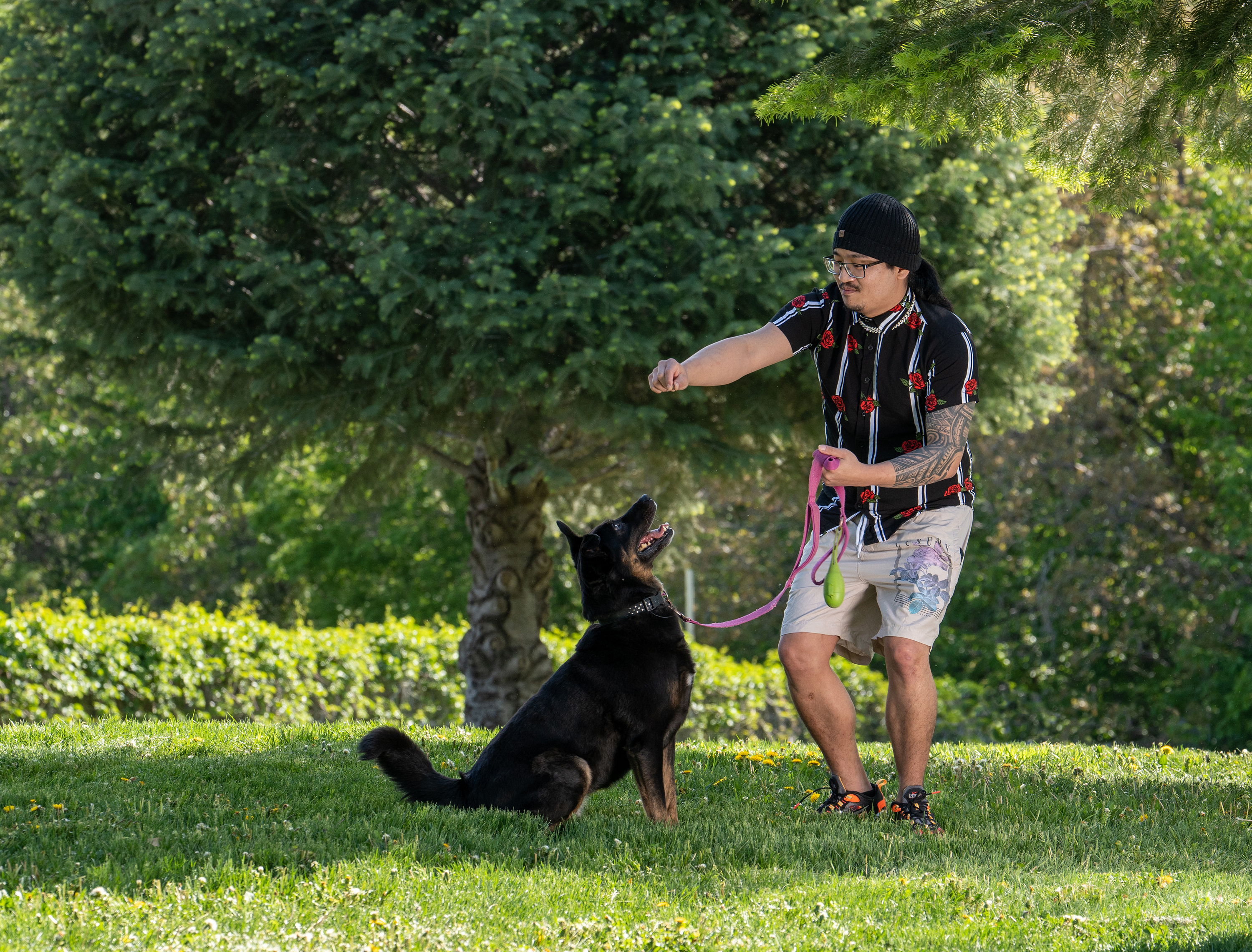 Picture of patient Su Lee playing outside with his black dog