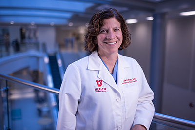 Torri Metz, MD, MS, standing at a hospital walkway