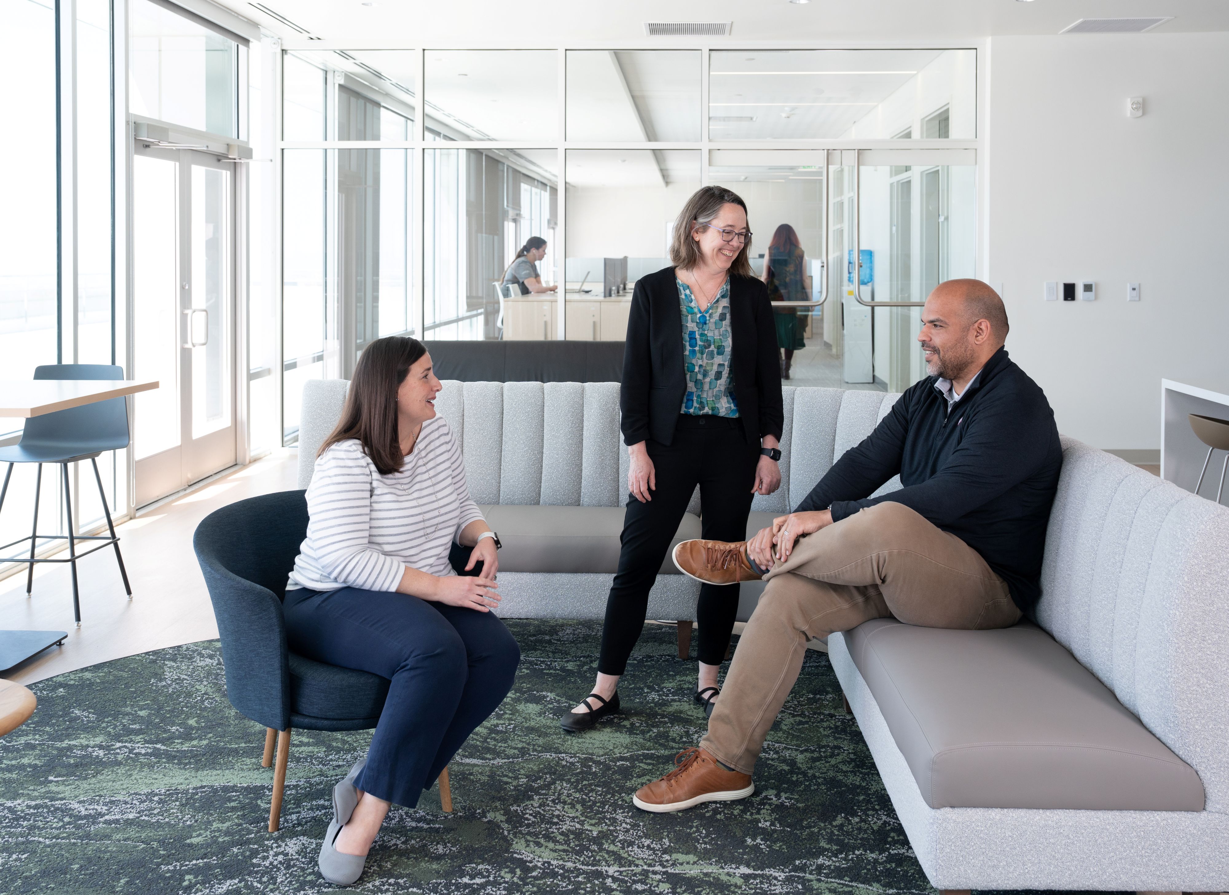 Dr. Amy Locke chats with Justin Jackson and Ellen Maxfield in the break room.
