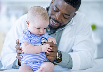 Doctor with baby, NIH grants
