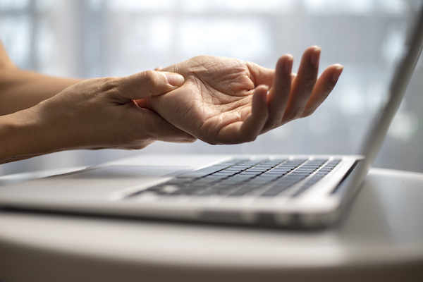 Person holding their hand over a keyboard