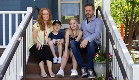 Picture of Edith Molstad sitting with her family on the porch