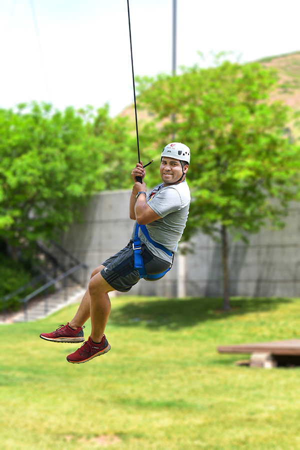 Joe Walker hanging from climbing rope at HMHI ROPES Course