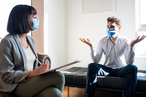 Person with mask in therapy session