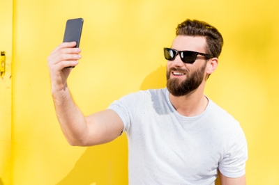 Man in sunglasses taking a selfie