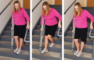 Walking down the stairs with crutches using a handrail