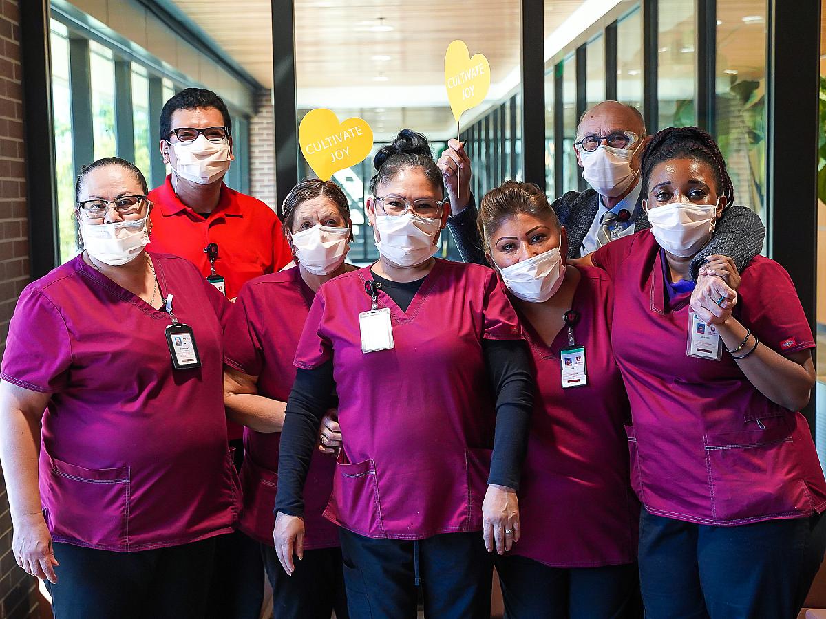 Picture of group of HMHI providers wearing maroon scrubs and face masks