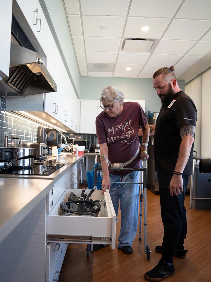 A stroke patient navigates the kitchen as part of their rehabilitation care.