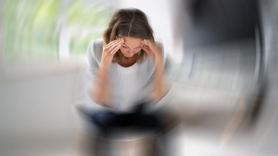 Woman experiencing spinning and dizziness