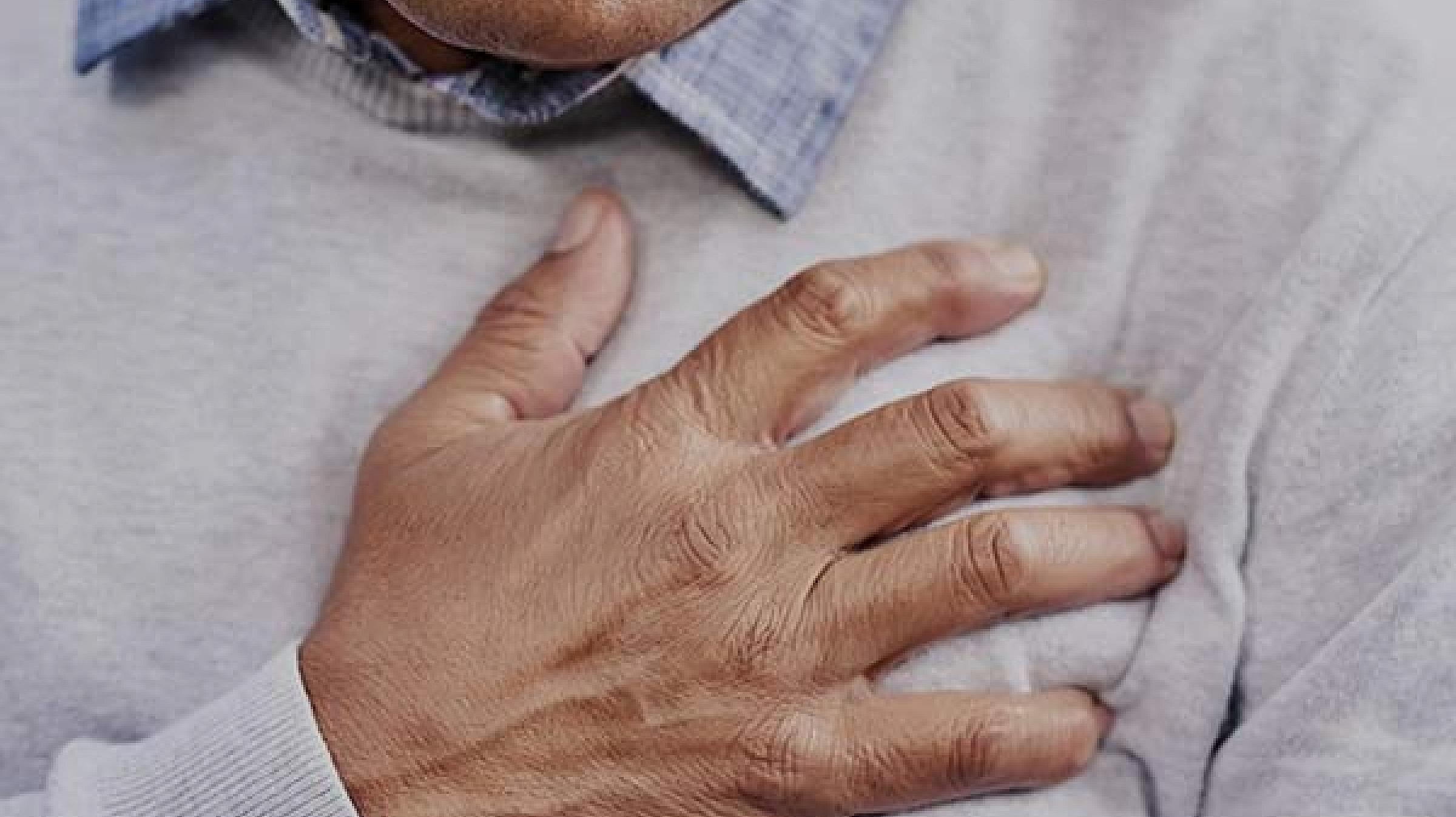 Man clutching chest over heart