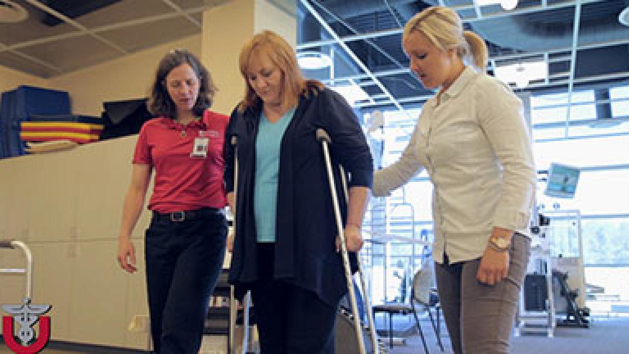 Patient with hip replacement practicing with crutches
