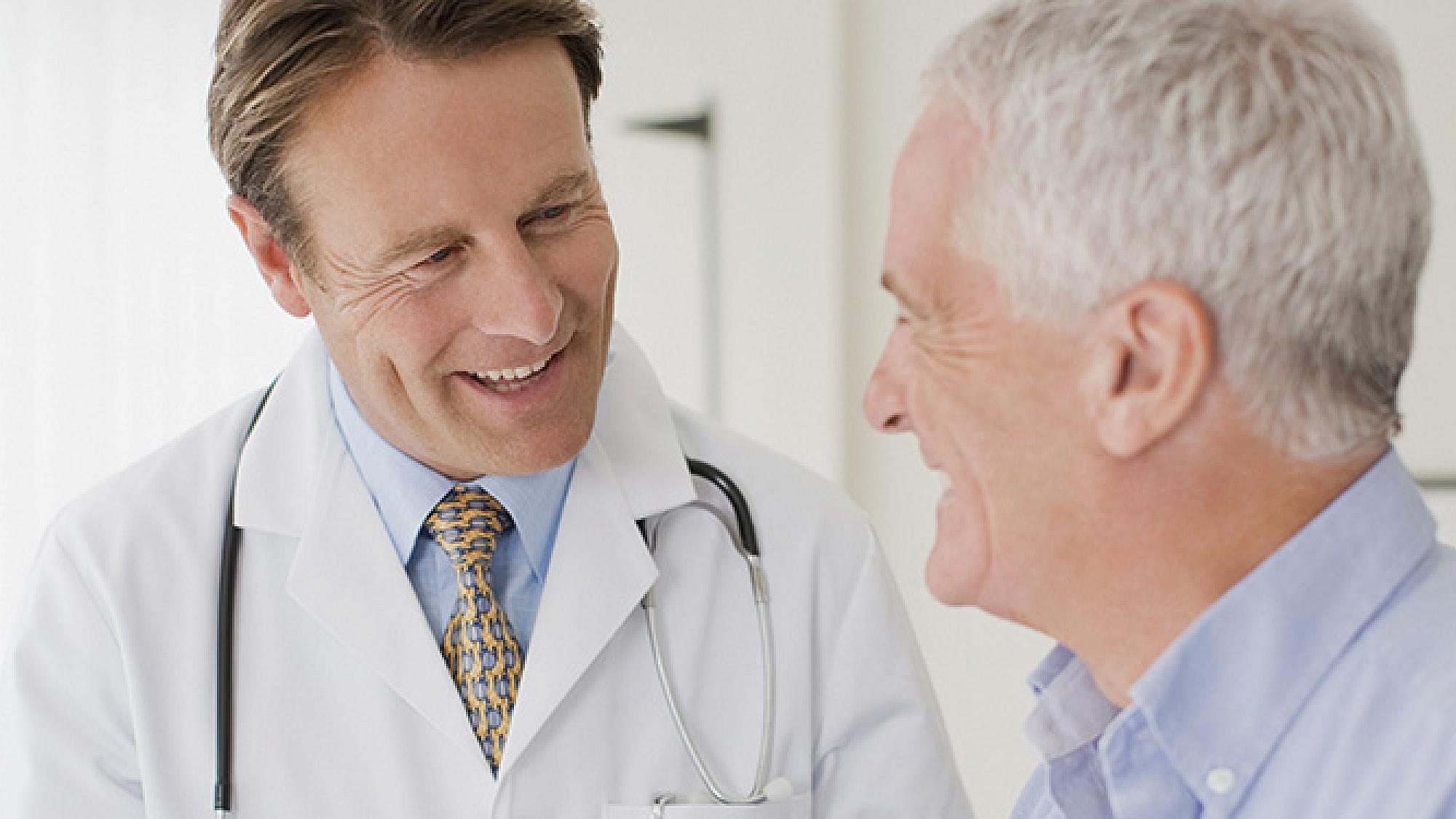 Male doctor speaking to male patient