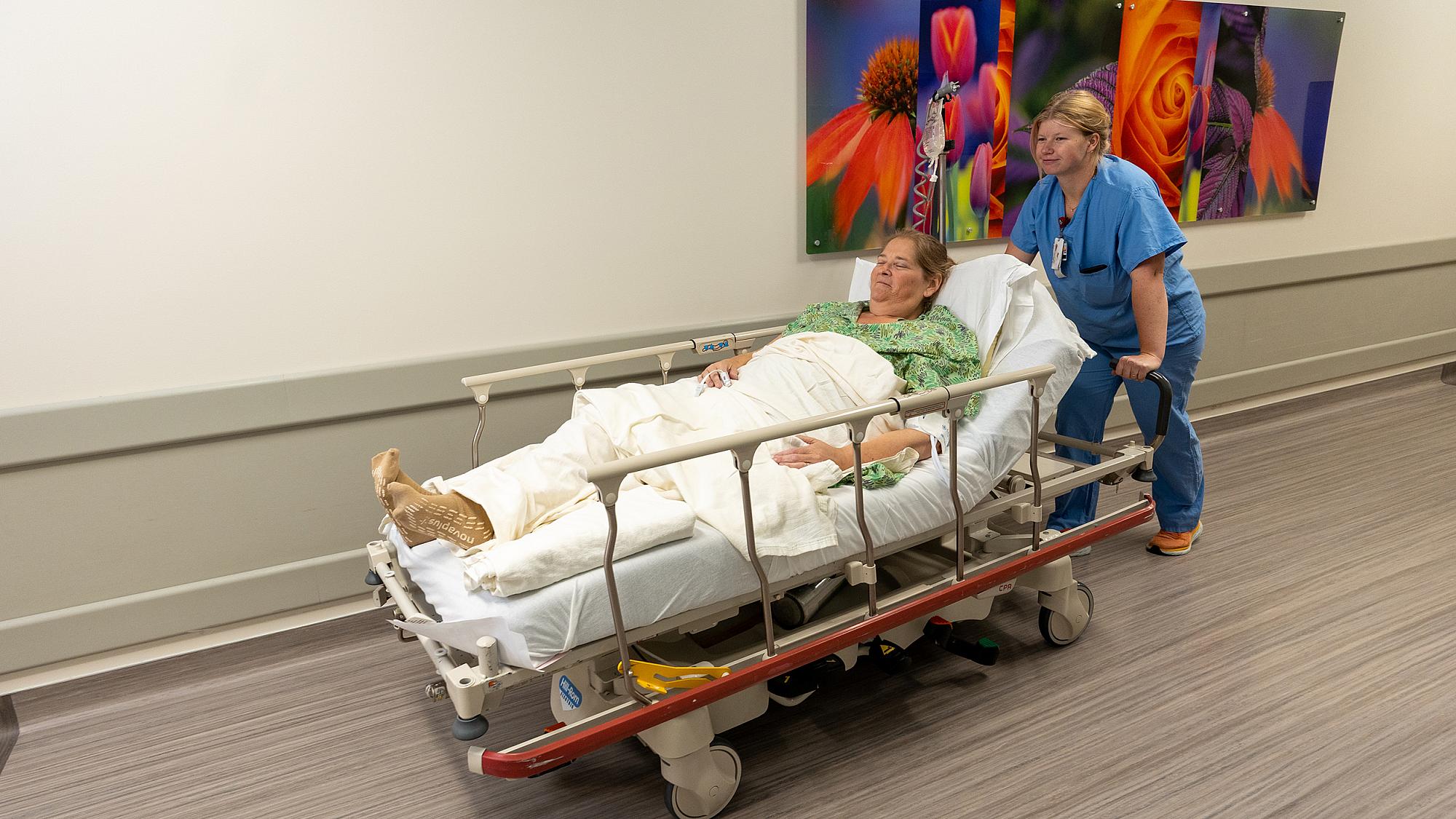 U of U Health cardiovascular patient being wheeled down the hall at University of Utah Hospital